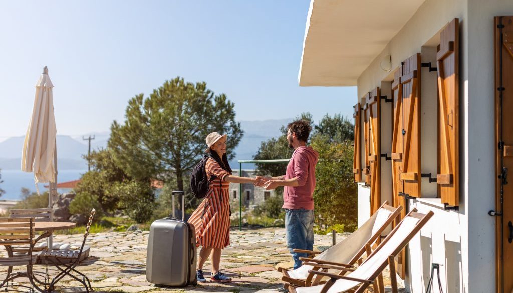 Host welcoming guest at house rental