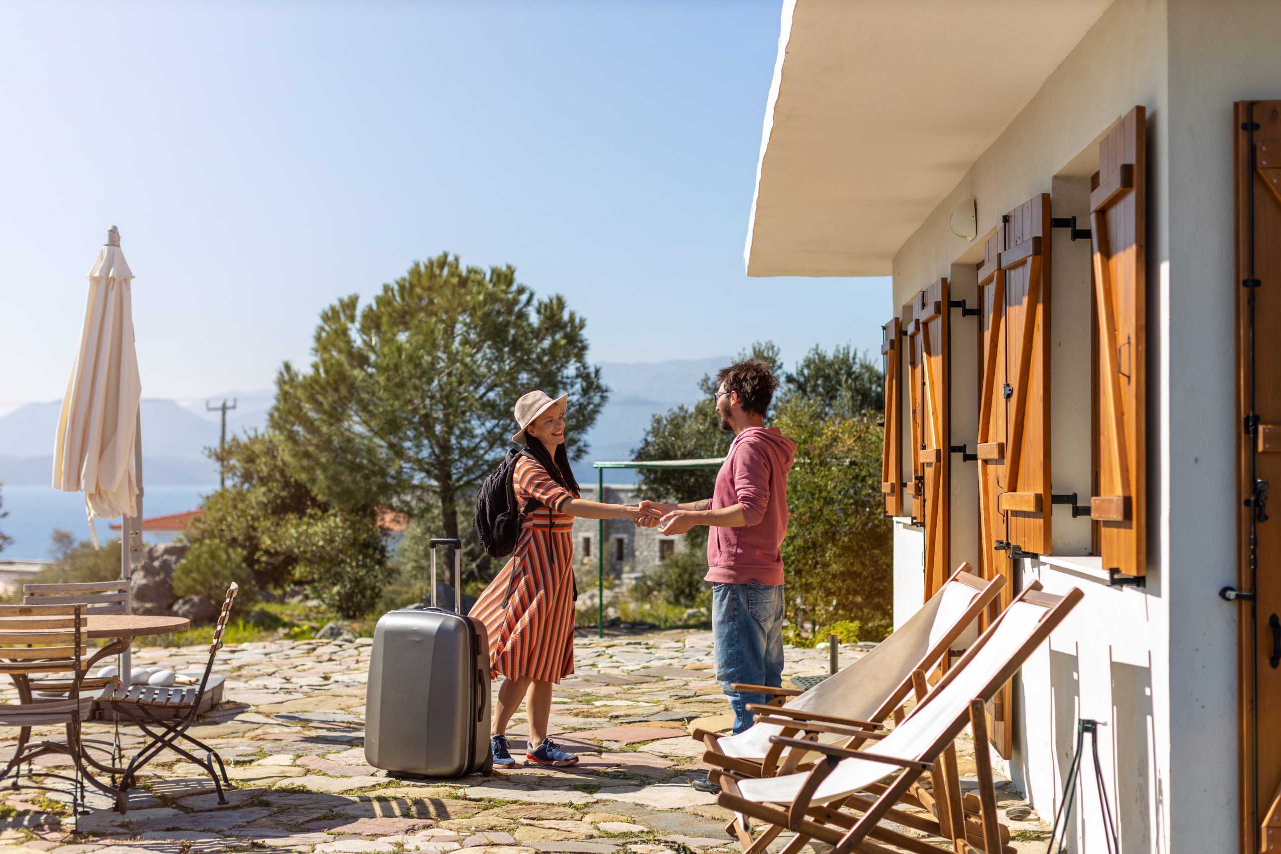 Host welcoming guest at house rental Host welcoming guest at house rental